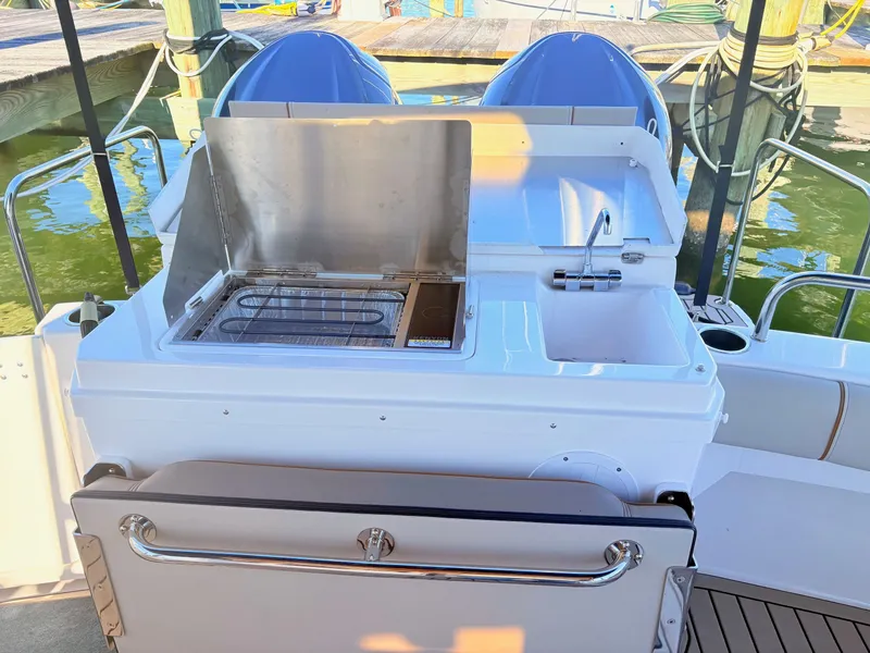 Slide: The Image of 2023 Cutwater 32 Coupe with outdoor kitchen and sink at dock. - 12