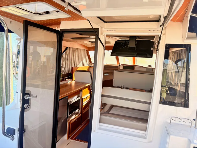 Slide: The Image of Interior view of 2023 Cutwater 32 Coupe with modern amenities. - 14