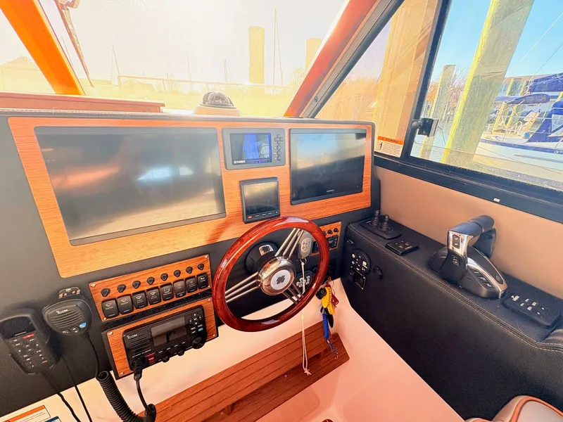 Slide: The Image of Interior view of a 2023 Cutwater 32 Coupe boat cockpit. - 19