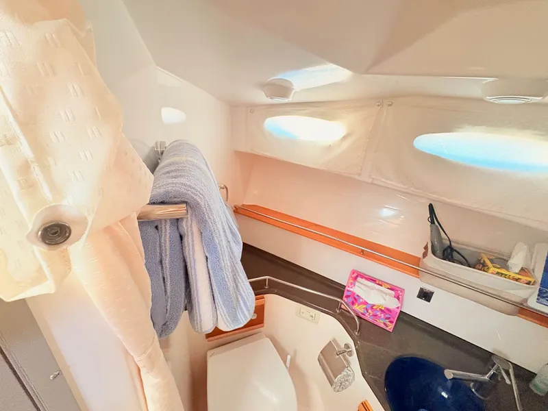 Slide: The Image of Interior of 2023 Cutwater 32 Coupe featuring bathroom and towels. - 23