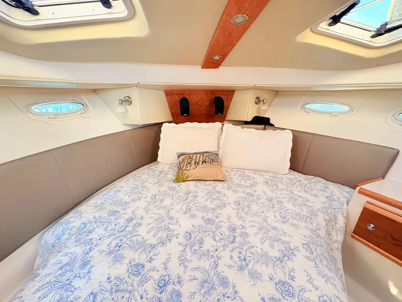 Slide: The Image of Interior of 2023 Cutwater 32 Coupe featuring cozy bed. - 24
