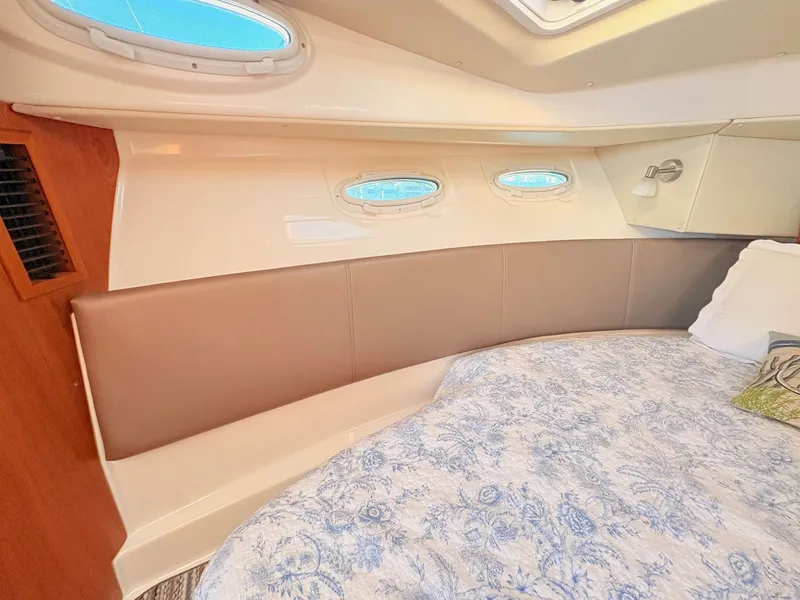 Slide: The Image of Interior of 2023 Cutwater 32 Coupe with bed and portholes. - 25