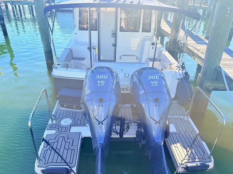 Slide: The Image of 2023 Cutwater 32 Coupe with twin 300 HP V6 engines at the dock. - 3