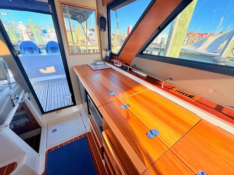 Slide: The Image of Interior of 2023 Cutwater 32 Coupe with wooden finish. - 30