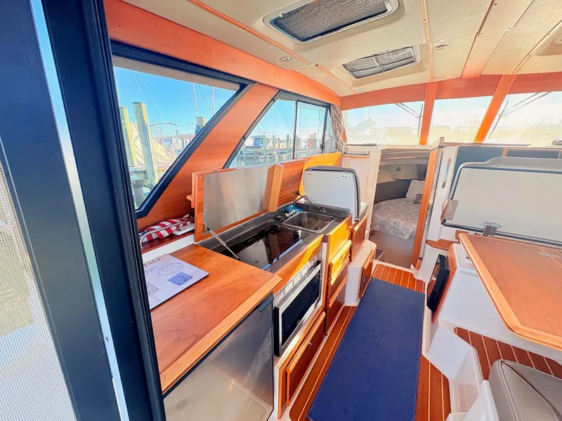 Slide: The Image of Interior of 2023 Cutwater 32 Coupe featuring modern kitchen. - 32