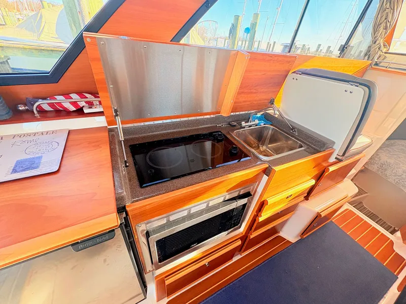 Slide: The Image of Interior of 2023 Cutwater 32 Coupe featuring modern kitchen. - 33