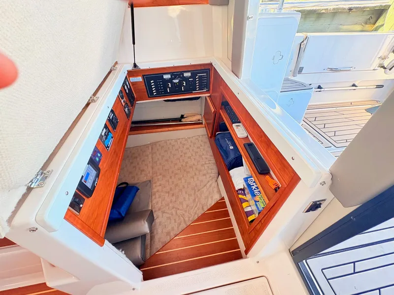 Slide: The Image of Interior of 2023 Cutwater 32 Coupe with controls and storage. - 36