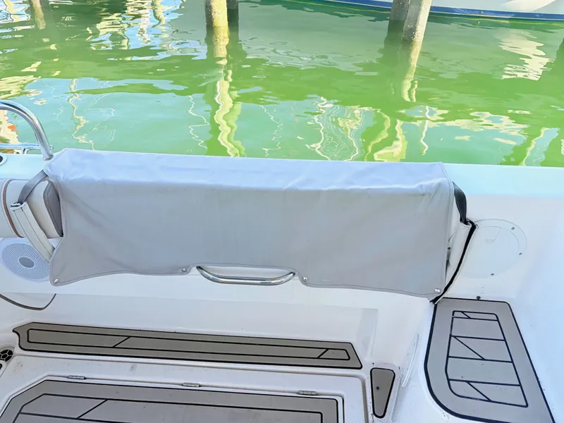 Slide: The Image of 2023 Cutwater 32 Coupe boat with gray cover at dock. - 9