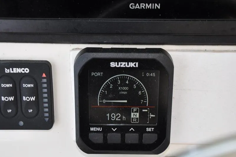 Slide: The Image of Control panel of a 2006 Pursuit 345 Drummond Sportfish boat with Suzuki gauge. - 11