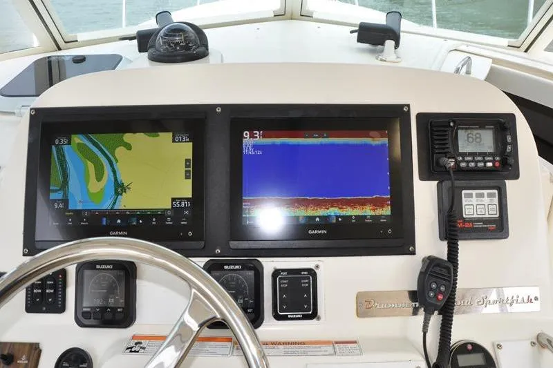 Slide: The Image of Dashboard of 2006 Pursuit 345 Drummond Sportfish with Garmin navigation displays. - 12
