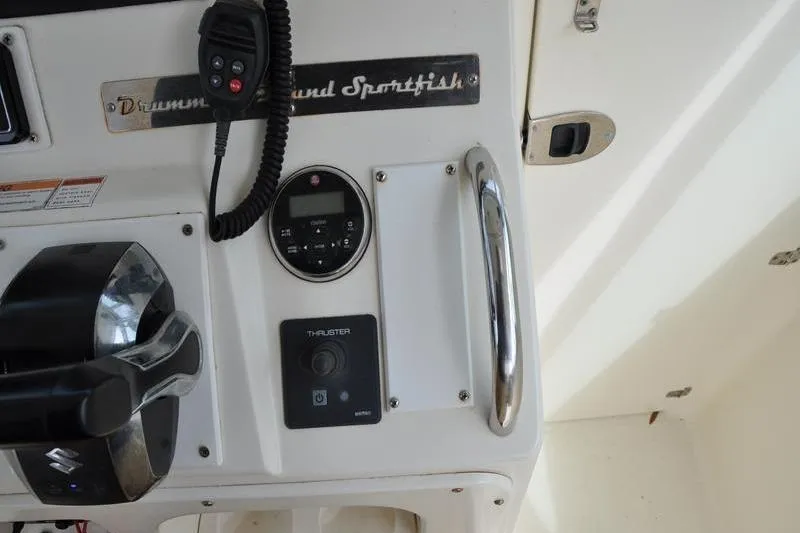 Slide: The Image of Control panel of a 2006 Pursuit 345 Drummond Sportfish boat with throttle and thruster controls. - 15