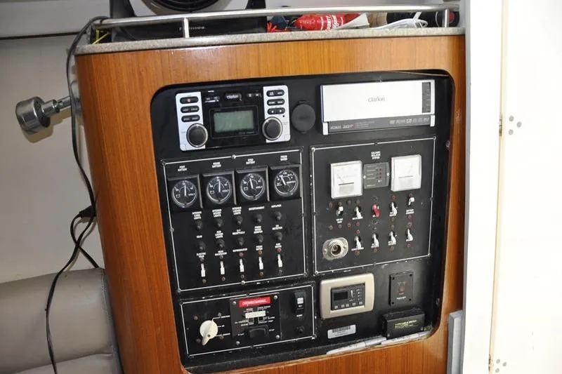 Slide: The Image of Control panel of a 2006 Pursuit 345 Drummond Sportfish boat, featuring gauges and switches. - 16