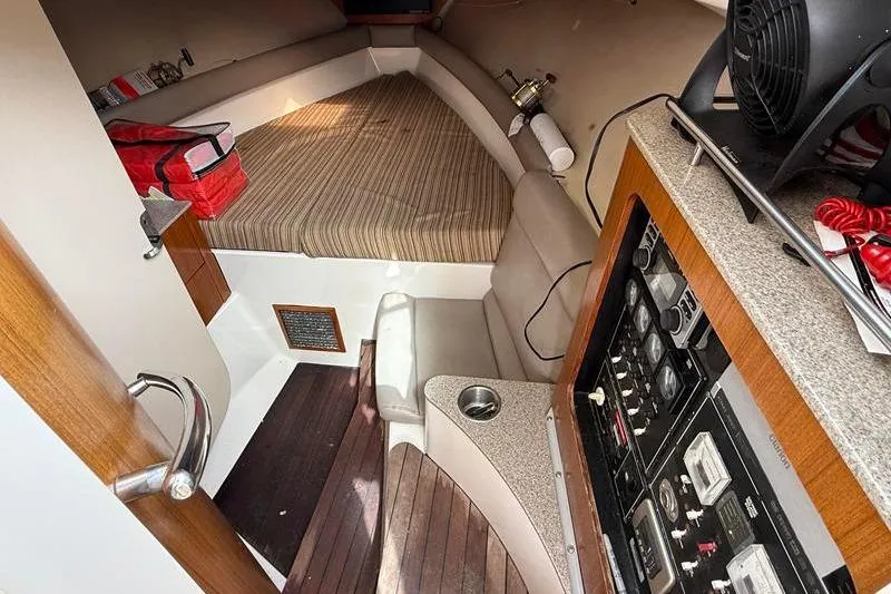 Slide: The Image of Interior of a 2006 Pursuit 345 Drummond Sportfish boat with seating and control panel. - 17