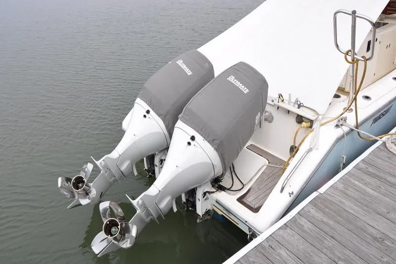 Slide: The Image of Twin outboard motors on a 2006 Pursuit 345 Drummond Sportfish boat at dock. - 2