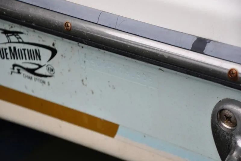 Slide: The Image of Close-up of 2006 Pursuit 345 Drummond Sportfish boat hull with logo and metal fittings. - 20