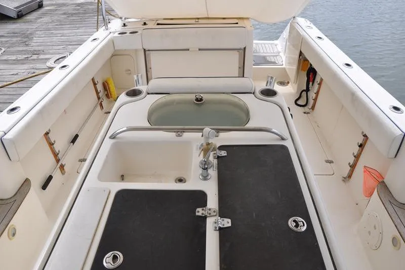 Slide: The Image of 2006 Pursuit 345 Drummond Sportfish boat deck with fishing amenities and storage. - 3