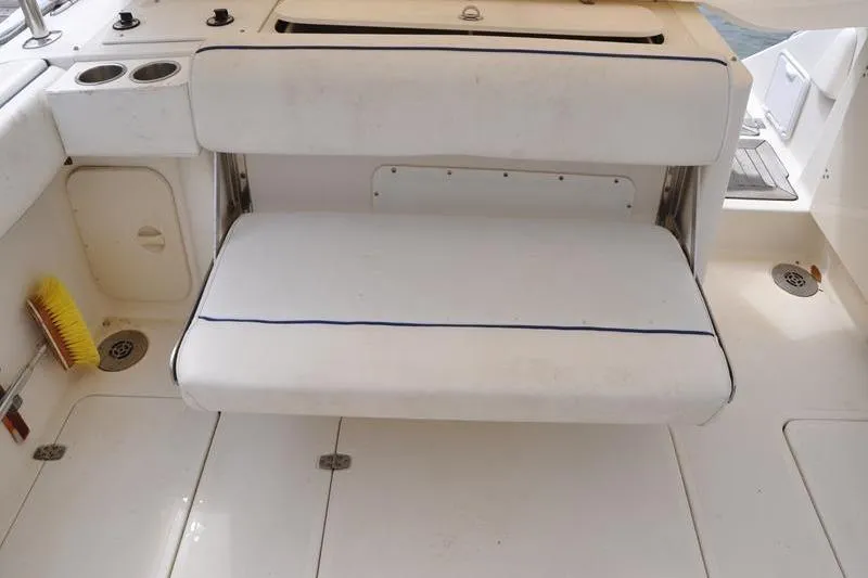 Slide: The Image of 2006 Pursuit 345 Drummond Sportfish boat interior with white seating and deck. - 4