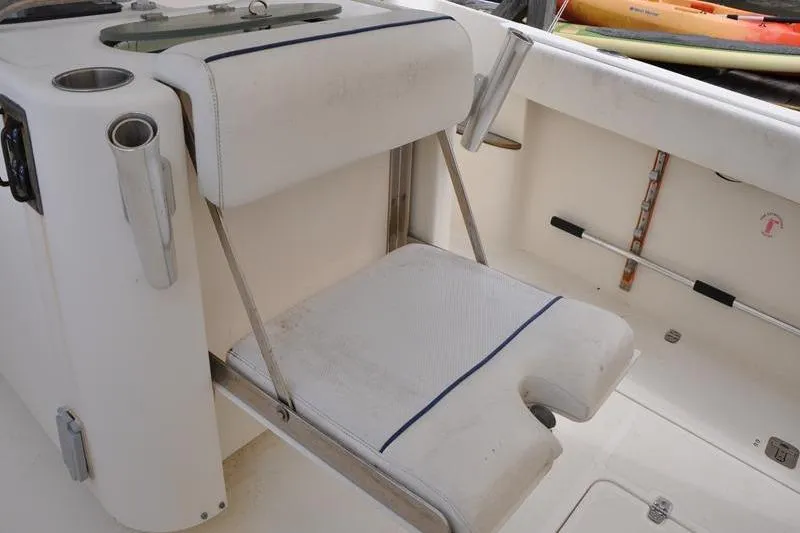 Slide: The Image of 2006 Pursuit 345 Drummond Sportfish boat seat with rod holders and storage. - 7