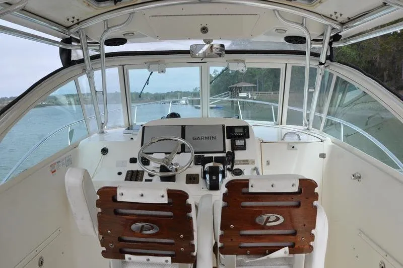 Slide: The Image of Interior view of 2006 Pursuit 345 Drummond Sportfish boat cockpit with Garmin navigation system. - 8