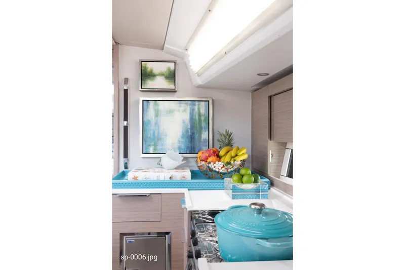Slide: The Image of Modern kitchen interior of 2023 Hanse 460 yacht with fruit basket and turquoise cookware. - 11