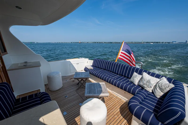 Slide: The Image of Luxurious 2017 Grand Banks 44 Eastbay SX yacht deck with striped seating and ocean view. - 13