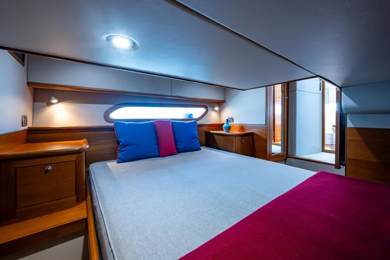 Slide: The Image of Luxurious cabin interior of 2017 Grand Banks 44 Eastbay SX yacht, featuring elegant wood finishes. - 4