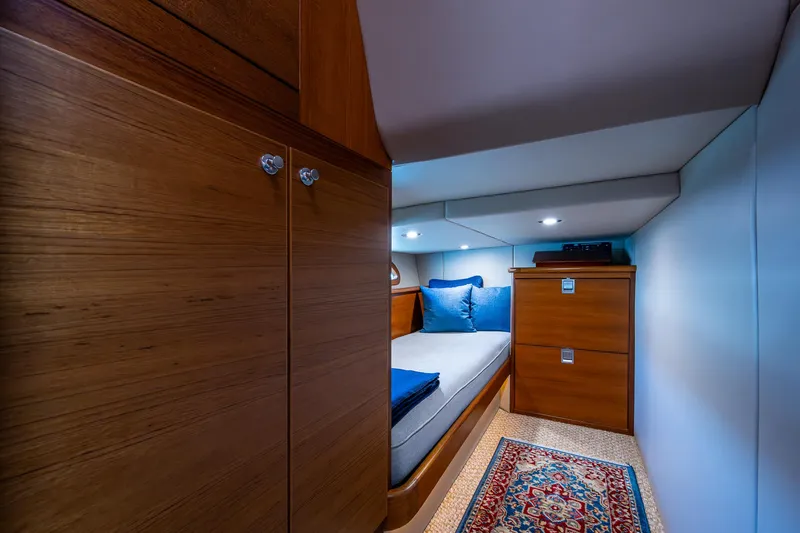 Slide: The Image of Luxurious cabin interior of 2017 Grand Banks 44 Eastbay SX with wood finish and cozy bedding. - 41