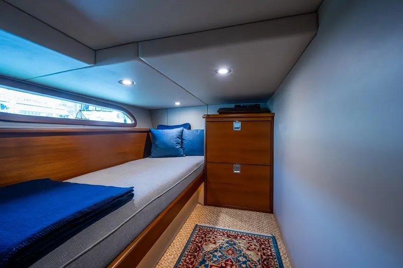 Slide: The Image of Cabin interior of 2017 Grand Banks 44 Eastbay SX with cozy bed and wooden storage. - 42