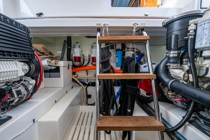 Slide: The Image of Engine room of 2017 Grand Banks 44 Eastbay SX with equipment and ladder. - 46