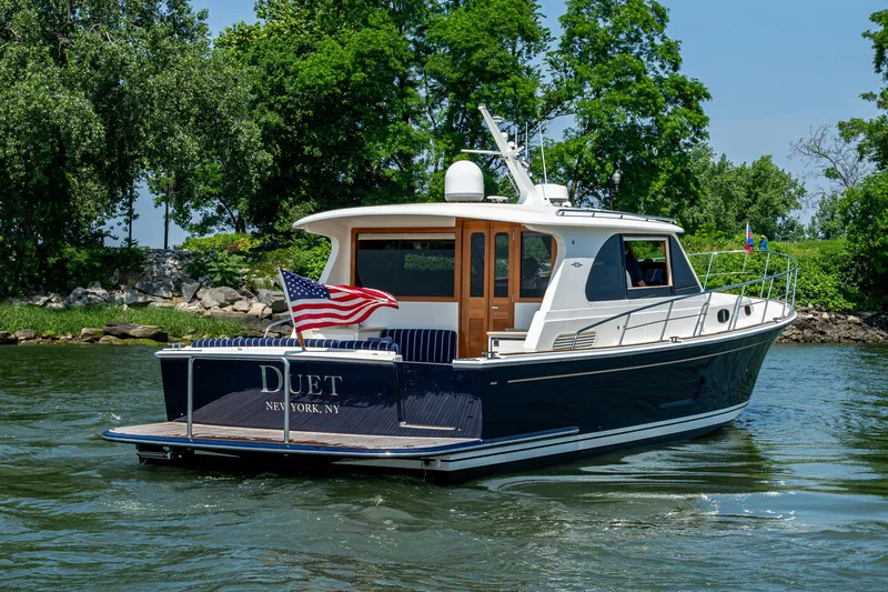 Slide: The Image of 2017 Grand Banks 44 Eastbay SX yacht cruising on a scenic waterway. - 8