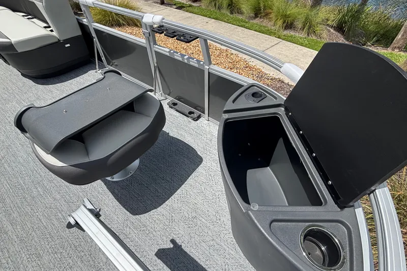 Slide: The Image of 2026 Sun Tracker Party Barge 20 DLX interior with seating and storage compartments. - 15