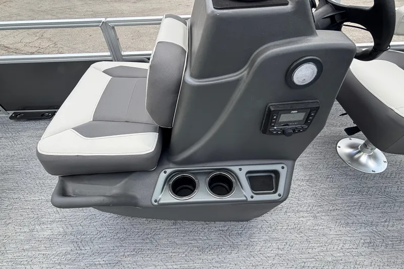 Slide: The Image of 2026 Sun Tracker Party Barge 20 DLX interior with gray seating and control panel. - 19