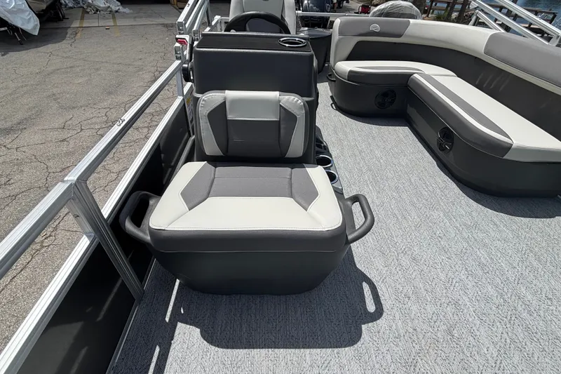 Slide: The Image of 2026 Sun Tracker Party Barge 20 DLX interior with gray seating and spacious layout. - 17