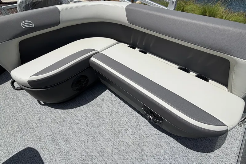 Slide: The Image of 2026 Sun Tracker Party Barge 20 DLX seating area with gray and white upholstery. - 14