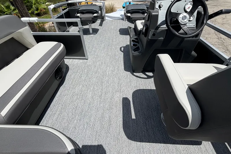Slide: The Image of 2026 Sun Tracker Party Barge 20 DLX interior with seating and steering console. - 13
