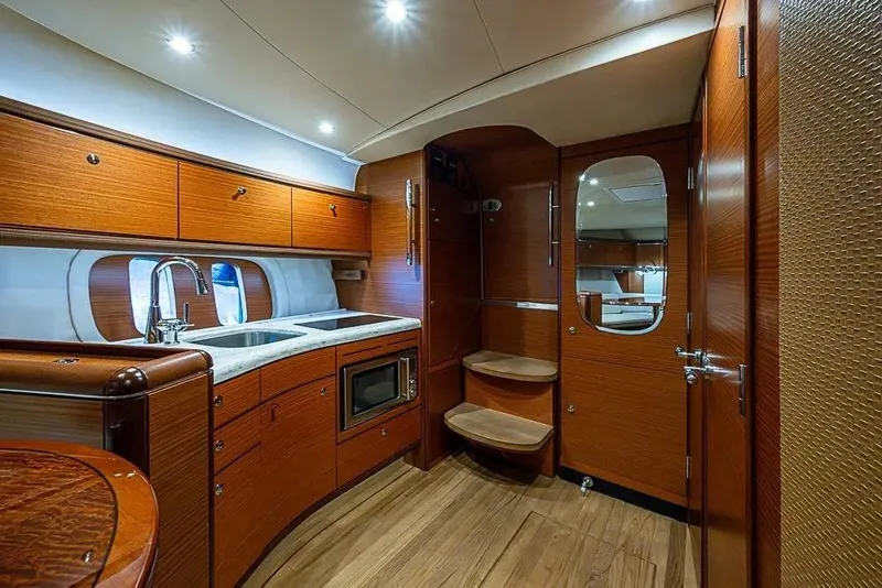 Slide: The Image of Luxurious 2014 Zeelander Z44 yacht interior with wooden cabinetry and modern kitchen amenities. - 20