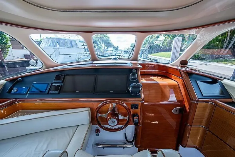 Slide: The Image of Interior of 2014 Zeelander Z44 yacht with luxurious wood finish and modern navigation controls. - 7