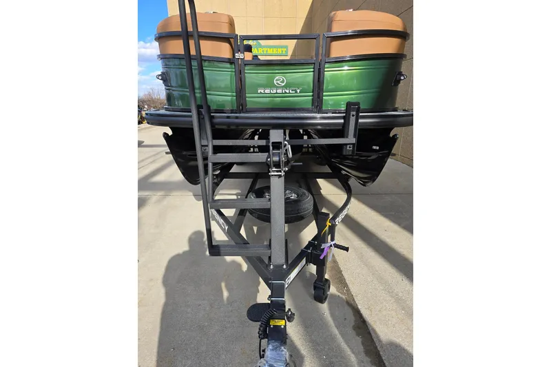 Slide: The Image of 2026 Regency 230 DL boat interior with tan seating and modern design. - 4