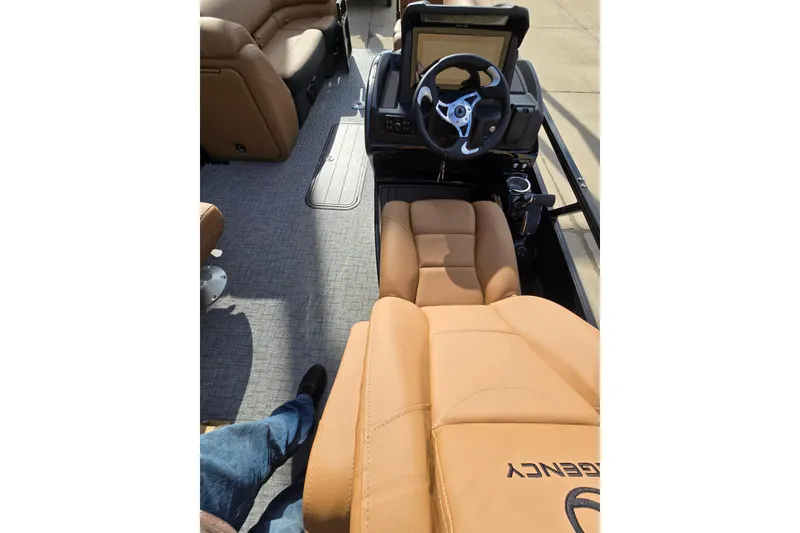 Slide: The Image of Interior of 2026 Regency 230 DL pontoon boat with tan seating and modern helm. - 5