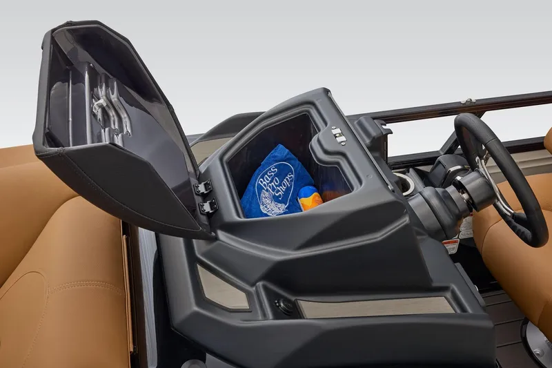 Slide: The Image of 2026 Regency 230 DL boat console with storage compartment open, revealing a towel and snacks. - 25