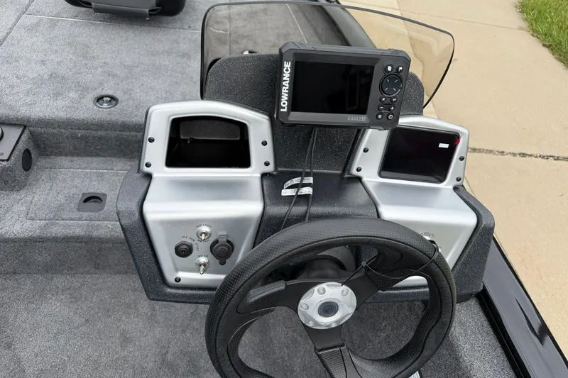 Slide: The Image of 2026 Tracker Pro Team 175 boat dashboard with steering wheel and electronic display. - 15