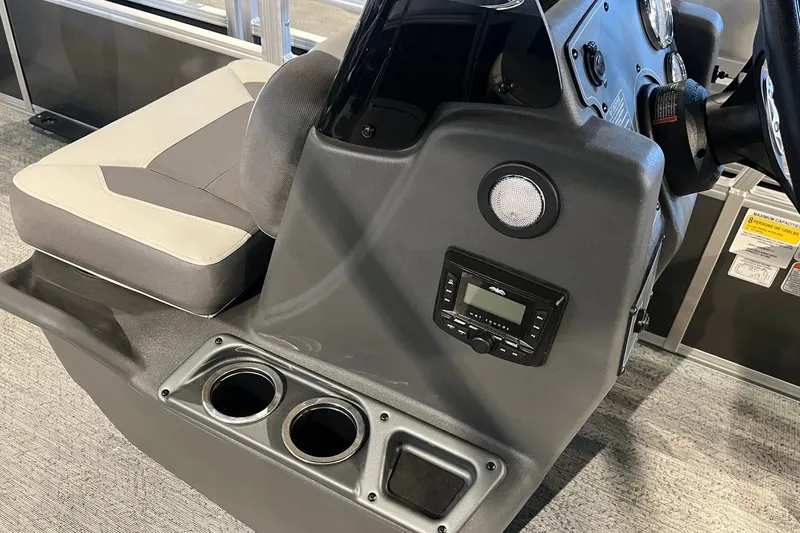 Slide: The Image of 2026 Sun Tracker Bass Buggy 18 DLX console with cup holders and control panel. - 23