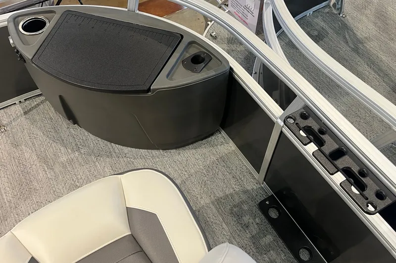 Slide: The Image of 2026 Sun Tracker Bass Buggy 18 DLX interior with seating and storage compartments. - 24