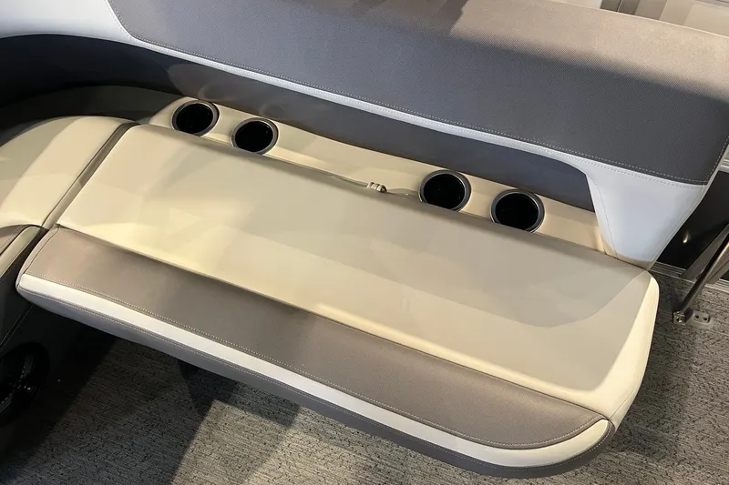 Slide: The Image of 2026 Sun Tracker Bass Buggy 18 DLX boat seating with cup holders, beige and gray upholstery. - 14