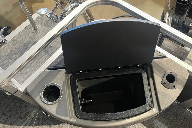 Slide: The Image of 2026 Sun Tracker Bass Buggy 18 DLX boat storage compartment with cup holder. - 19