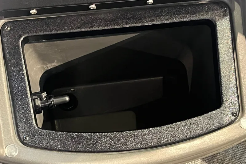 Slide: The Image of Storage compartment of 2026 Sun Tracker Bass Buggy 18 DLX boat, featuring a secure latch. - 20