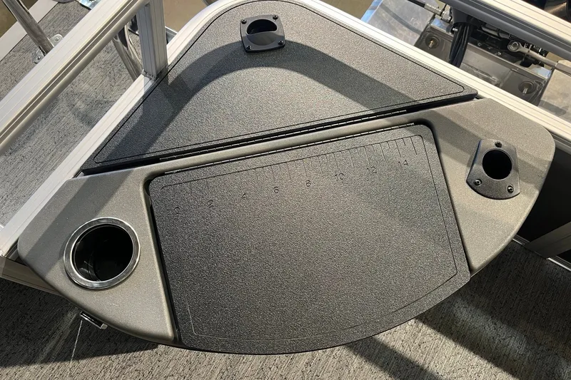 Slide: The Image of 2026 Sun Tracker Bass Buggy 18 DLX fishing station with cup holders and measuring board. - 18