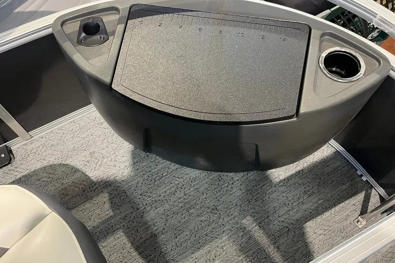 Slide: The Image of 2026 Sun Tracker Bass Buggy 18 DLX interior with cup holder and storage compartment. - 29