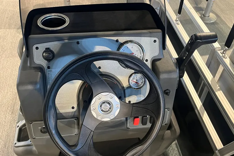 Slide: The Image of Steering console of 2026 Sun Tracker Bass Buggy 18 DLX with gauges and controls. - 22