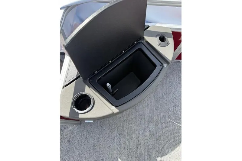 Slide: The Image of 2026 Sun Tracker Bass Buggy 18 DLX boat storage compartment with cup holder. - 10